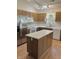 Bright kitchen with a center island, white countertops and wooden cabinets at 1103 Charleston Commons Dr, Anderson, IN 46012