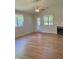 Cozy living room featuring hardwood floors, fireplace, and natural light at 1103 Charleston Commons Dr, Anderson, IN 46012