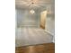 Bright living room featuring neutral walls, carpet, and an elegant light fixture at 1103 Charleston Commons Dr, Anderson, IN 46012