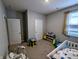 Bedroom with crib, changing table, and neutral colored walls at 11064 N Sashing Way, Monrovia, IN 46157