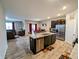 Modern kitchen featuring an island, stainless steel appliances, and adjacent living area at 11064 N Sashing Way, Monrovia, IN 46157