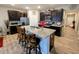 Spacious kitchen with a large center island, dark cabinets, stainless steel appliances, and stylish barstool seating at 11064 N Sashing Way, Monrovia, IN 46157