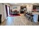 Open-concept kitchen with dining area featuring dark wood furniture, stainless steel appliances, and a center island with bar seating at 11064 N Sashing Way, Monrovia, IN 46157