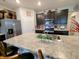 Kitchen featuring dark cabinets, stainless steel appliances, a mosaic backsplash, and a large island with a sink at 11064 N Sashing Way, Monrovia, IN 46157
