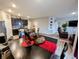Open-concept living space with kitchen, dining area, and living room with hardwood floors and modern decor at 11064 N Sashing Way, Monrovia, IN 46157