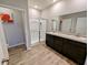 This spacious main bathroom has a double vanity, a shower, and modern cabinets at 11064 N Sashing Way, Monrovia, IN 46157
