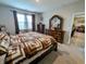 This lovely main bedroom features a large bed, a dresser, and an open door to the rest of the house at 11064 N Sashing Way, Monrovia, IN 46157