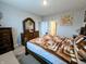 This is a lovely main bedroom with a large bed, a dresser, and an open door to the main bath at 11064 N Sashing Way, Monrovia, IN 46157
