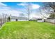 Spacious backyard featuring green grass, a storage shed, and a wooden fence for added privacy at 11363 Kristen Ln, Indianapolis, IN 46235