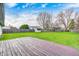 Spacious backyard with a wooden deck, lawn and trees providing a place for outdoor activities at 11363 Kristen Ln, Indianapolis, IN 46235