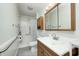 Bathroom featuring a vanity, mirror, shower-tub combination with grab bars and a toilet at 11363 Kristen Ln, Indianapolis, IN 46235