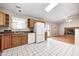 Open kitchen featuring updated appliances, white tile flooring, and access to the living room at 11363 Kristen Ln, Indianapolis, IN 46235