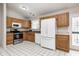 Bright kitchen featuring white appliances, wooden cabinets and ample counter space at 11363 Kristen Ln, Indianapolis, IN 46235