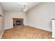 Inviting living room boasts hardwood floors, a cozy fireplace, and a modern ceiling fan at 11363 Kristen Ln, Indianapolis, IN 46235