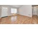 Inviting living room showcasing hardwood floors, a bright window, and an entry door at 11363 Kristen Ln, Indianapolis, IN 46235