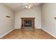 Warm living room with a brick fireplace, modern ceiling fan, and hardwood floors at 11363 Kristen Ln, Indianapolis, IN 46235