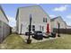 Backyard featuring patio furniture set on the rocks and green grass at 11614 Presidio Dr, Indianapolis, IN 46235