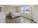 Bedroom featuring hardwood floors, 2 windows, and neutral-toned walls at 11614 Presidio Dr, Indianapolis, IN 46235
