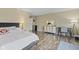 Bedroom showcasing hardwood floors, a writing desk, and neutral-toned walls at 11614 Presidio Dr, Indianapolis, IN 46235