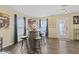 Open dining room with hardwood floors, a barrel table with 4 chairs, and a basketball game at 11614 Presidio Dr, Indianapolis, IN 46235