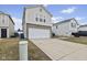 Exterior view of home with a two-car garage and long driveway at 11614 Presidio Dr, Indianapolis, IN 46235