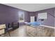 Spacious game room with ping pong table, hardwood floors, and a large window at 11614 Presidio Dr, Indianapolis, IN 46235