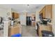 Traditional kitchen features tile flooring, wooden cabinets, and black appliances at 11614 Presidio Dr, Indianapolis, IN 46235