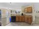 Traditional kitchen showcasing tile floors, wooden cabinets and stainless steel sink at 11614 Presidio Dr, Indianapolis, IN 46235
