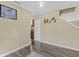 Open living space with wood-like flooring, stairs, and neutral walls at 11614 Presidio Dr, Indianapolis, IN 46235