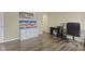 Office space with hardwood flooring, a large window, and a black office desk at 11614 Presidio Dr, Indianapolis, IN 46235