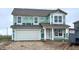 New two-story home features a two-car garage and a covered front porch that is currently under construction at 1346 Fleming Dr, Greenfield, IN 46140