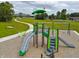 Playground with modern climbing structures, slides, and a swing set in a community park at 1346 Fleming Dr, Greenfield, IN 46140