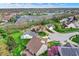 Scenic aerial view of a residential neighborhood with lush green lawns and a tranquil lake at 13841 Waywing Ct, Carmel, IN 46033