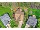 Overhead shot of a house with a wooden deck surrounded by mature trees and green lawns at 13841 Waywing Ct, Carmel, IN 46033