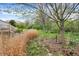 Secluded backyard featuring native plants, mature trees, and an access to a wooden deck at 13841 Waywing Ct, Carmel, IN 46033