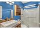 Modern bathroom featuring walk-in shower, floating sink, and blue painted walls at 13841 Waywing Ct, Carmel, IN 46033
