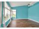 A spacious bedroom featuring hardwood floors, bright natural light, and ceiling fan at 13841 Waywing Ct, Carmel, IN 46033
