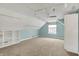 Bonus room featuring carpeted floors, track lighting, ceiling fan, and custom shelving at 13841 Waywing Ct, Carmel, IN 46033