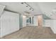 Spacious bonus room featuring carpeted floors, ceiling fan and custom wall-mounted shelving at 13841 Waywing Ct, Carmel, IN 46033