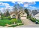 Charming home with a well-maintained front yard, mature trees, and a two-car garage at 13841 Waywing Ct, Carmel, IN 46033