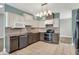 An open-concept kitchen with stainless appliances, tiled backsplash, and custom cabinets at 13841 Waywing Ct, Carmel, IN 46033