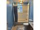 Bathroom featuring a tub, shower, toilet, and window at 1425 W 9Th St, Anderson, IN 46016