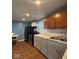 Modern kitchen equipped with stainless steel appliances, gray and white cabinets, and laminate countertops at 1425 W 9Th St, Anderson, IN 46016