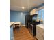 Bright kitchen with updated appliances, including a stainless steel stove and a new refrigerator at 1425 W 9Th St, Anderson, IN 46016