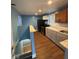 Well-lit kitchen boasting modern appliances, sleek gray and white cabinets, plus a charming dining area at 1425 W 9Th St, Anderson, IN 46016