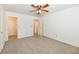 Spacious bedroom featuring neutral carpet, a ceiling fan with light, and multiple entryways at 1507 Park Dr, Lebanon, IN 46052