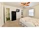 Bright bedroom featuring carpeted floors, ceiling fan, adjacent closet and ensuite at 1507 Park Dr, Lebanon, IN 46052