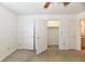 Bright bedroom with neutral carpet, ceiling fan, and access to a walk-in closet at 1507 Park Dr, Lebanon, IN 46052