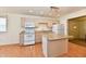 Bright open kitchen showcasing center island, modern appliances, hardwood floors, and an open layout at 1507 Park Dr, Lebanon, IN 46052