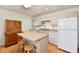 Cozy kitchen with white appliances, kitchen island, and wood-look flooring at 1507 Park Dr, Lebanon, IN 46052